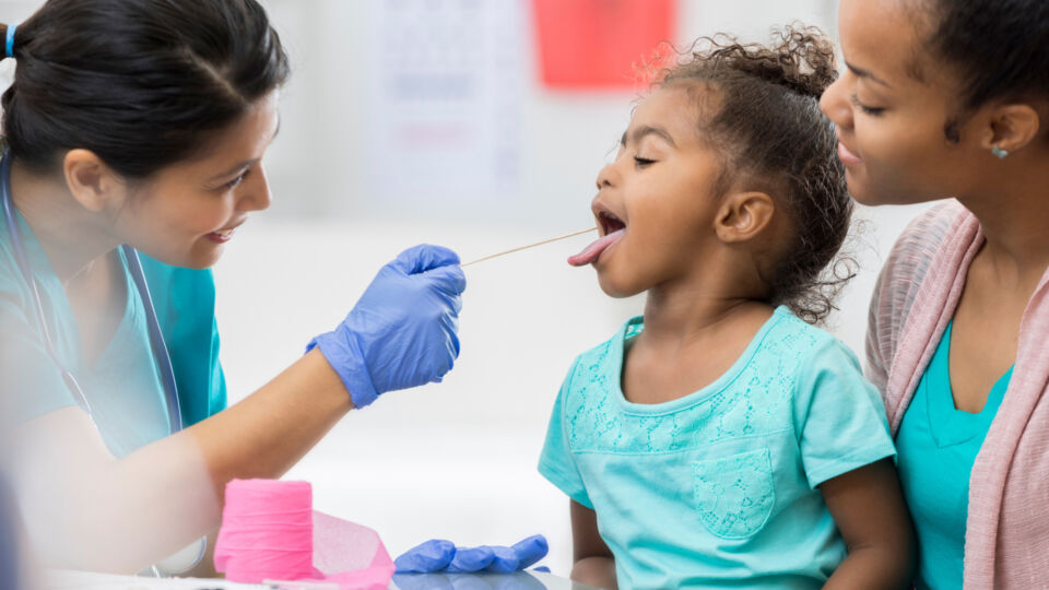 Nurse tests child with a mouth swab