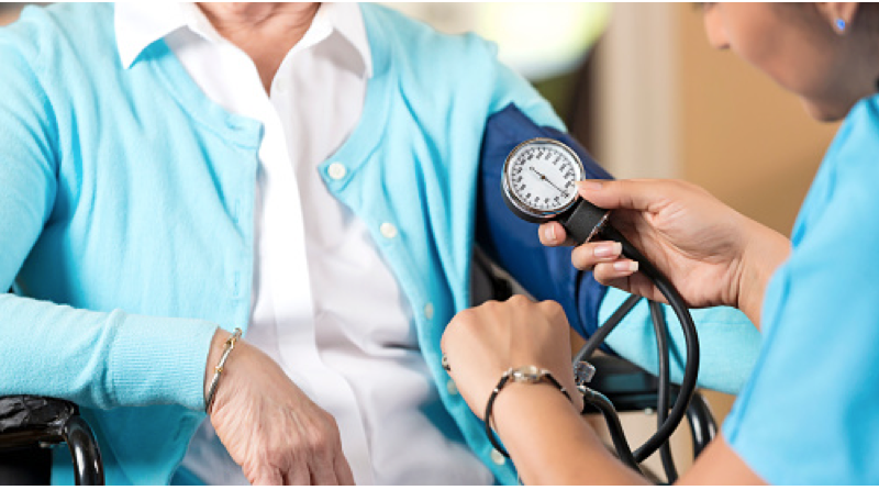 Physician Checking Patient's blood pressure